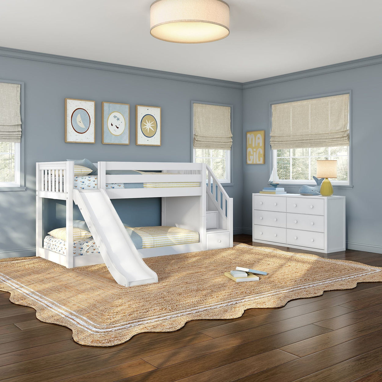 White wooden bunk bed with slide and storage stairs in a light-blue children's bedroom with woven area rug, white dresser, and natural light