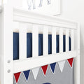 Close-up of white wooden baby crib slats with navy blue knitted blanket and red-white-blue bunting nursery decor