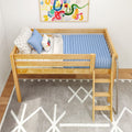 Wooden loft-style toddler bed with ladder, blue ribbed mattress and star-patterned pillows in a modern nursery with colorful abstract wall art and gray geometric rug