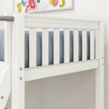 Close-up of white wooden crib rail with vertical slats, blue bedding and abstract nursery wall art