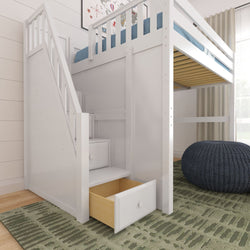 White wooden loft bed with staircase and built-in drawers for under-bed storage in a modern children's bedroom with blue knitted pouf and patterned green rug