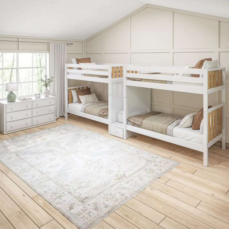 White wooden twin bunk beds in a bright neutral kids bedroom with board-and-batten accent wall, large window, dresser and area rug