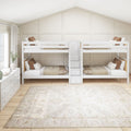 White twin bunk beds with center staircase storage in a neutral modern farmhouse kids' bedroom with board-and-batten gable wall, beige bedding, hardwood floors and natural light