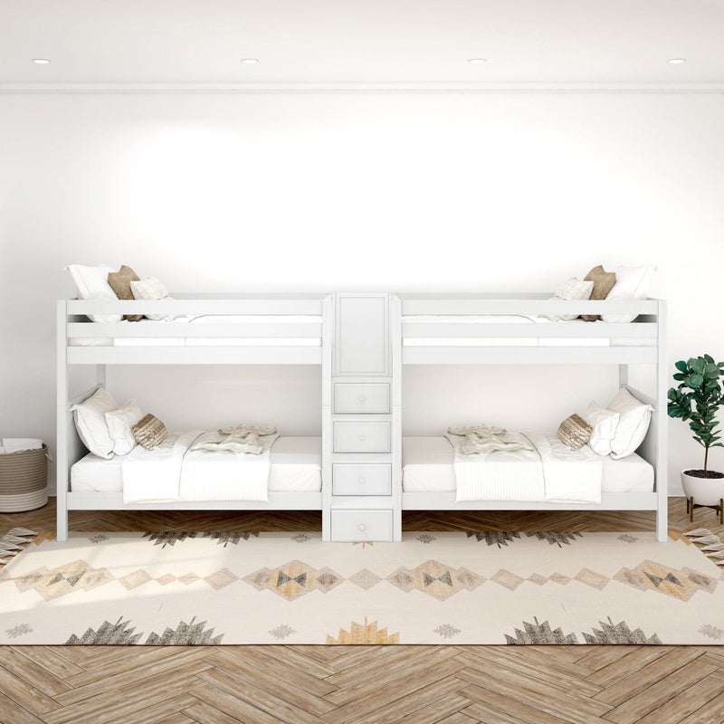 White bunk beds in a modern kids' bedroom with neutral decor, textured pillows, boho patterned rug and herringbone hardwood floor