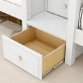 Open white dresser drawer with light wood interior and metal drawer slides on hardwood floor, modern bedroom storage solution