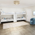 Kids' bedroom with white wooden bunk beds, cream shiplap walls, beige tile floor, woven drum ceiling light and blue accent chair