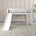 White kids loft bed with slide and ladder, blush bedding and pillows against beige paneled wall, minimalist children's bedroom decor