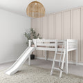 White wooden kids loft bed with slide and ladder in neutral nursery, blush vertical paneled accent wall, rattan pendant light and potted plant