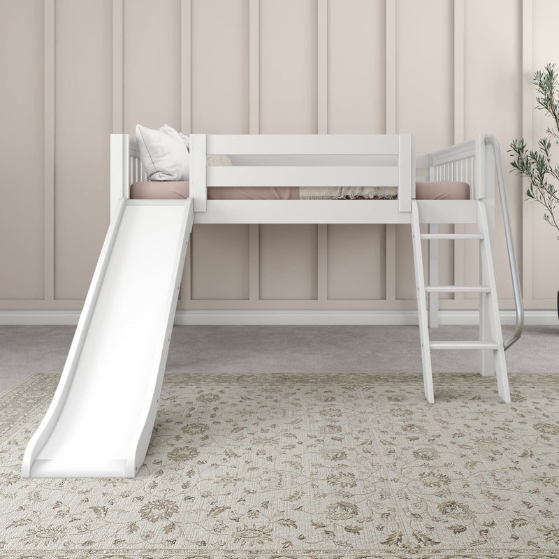 White kids loft bed with slide and ladder in neutral nursery — beige paneled wall, soft pillows, potted plant and patterned area rug