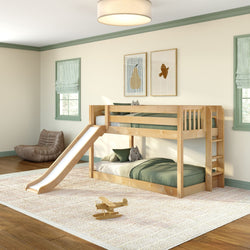 Natural wood kids bunk bed with slide in bright children's bedroom with green bedding, plush toys, wooden airplane, cozy rug