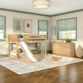 Kids bedroom with natural wood bunk bed and slide, green-trim windows with striped Roman shades, wooden dresser, lamp and toys on hardwood floor