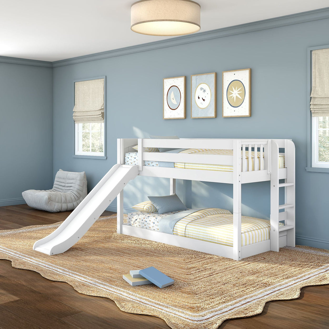 White wooden twin-over-twin bunk bed with slide and ladder in light-blue kids' bedroom, striped bedding, woven rug and wall art