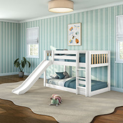 White twin-over-twin bunk bed with slide in modern kids bedroom, teal striped walls, blue bedding and plush toy on rug