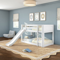 White twin-over-twin bunk bed with slide and ladder in a light blue kids' bedroom, striped bedding, natural jute rug and framed wall art