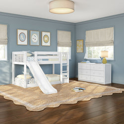 White twin bunk bed with slide in blue children's bedroom with white dresser, jute rug, hardwood floors and nautical decor
