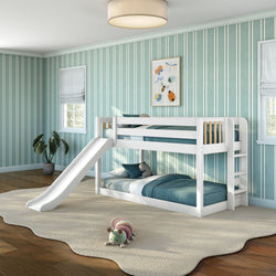 White wooden bunk bed with slide and ladder in modern children's bedroom with teal-striped wallpaper, blue bedding, cream area rug and plush caterpillar toy