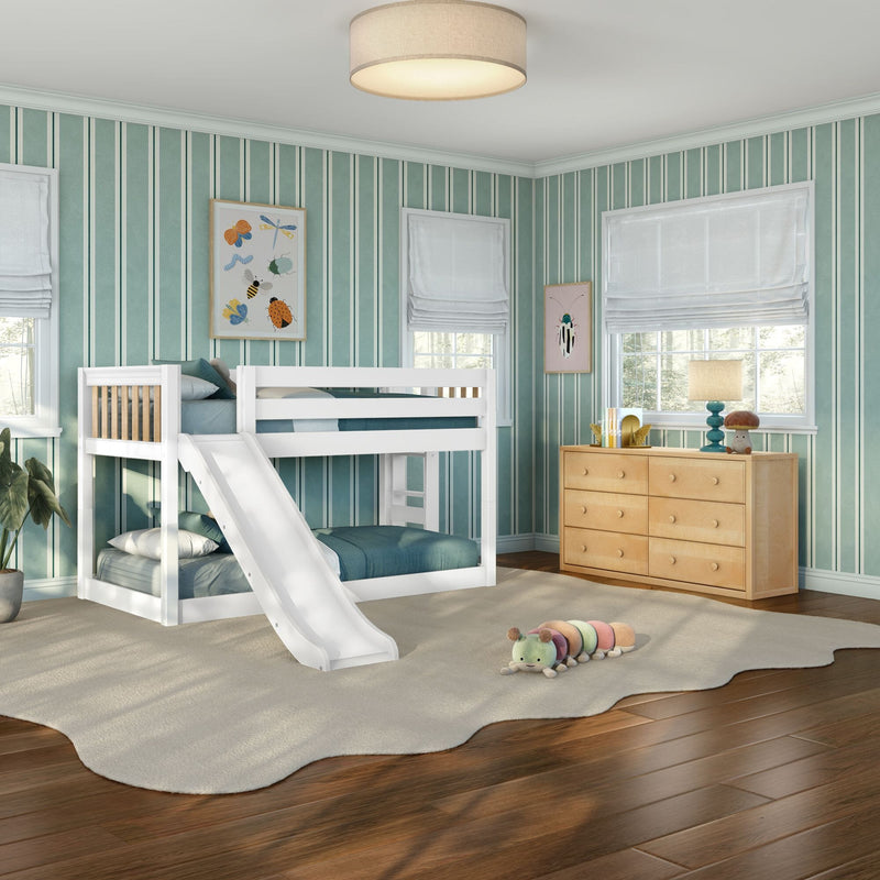 Kids bedroom with white bunk bed and slide, teal striped wallpaper, wooden dresser, lamp and plush caterpillar toy