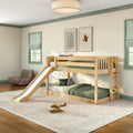Wooden bunk bed with slide in kids bedroom, green bedding and pillows, plush toys, striped Roman shades, framed wall art and wooden toy airplane