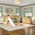 Kids bedroom with natural wood bunk bed and slide, striped Roman shades, green window trim, wooden dresser and cozy neutral decor
