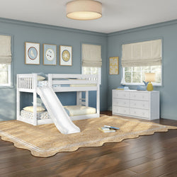 Kids' bedroom with white twin bunk bed and slide, blue walls, white dresser, woven rug, hardwood floor and nautical decor