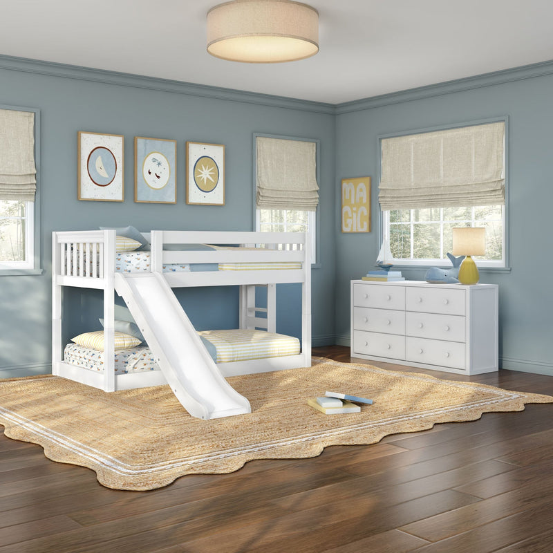 Kids bedroom with white bunk bed and slide, blue walls, white dresser, roman shades, jute rug and table lamp