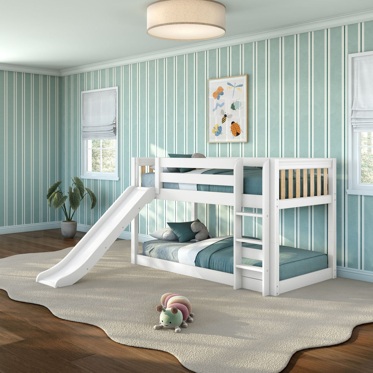 White wooden bunk bed with slide and ladder in modern kids' bedroom with teal striped wallpaper, hardwood floors, beige area rug, and plush caterpillar toy