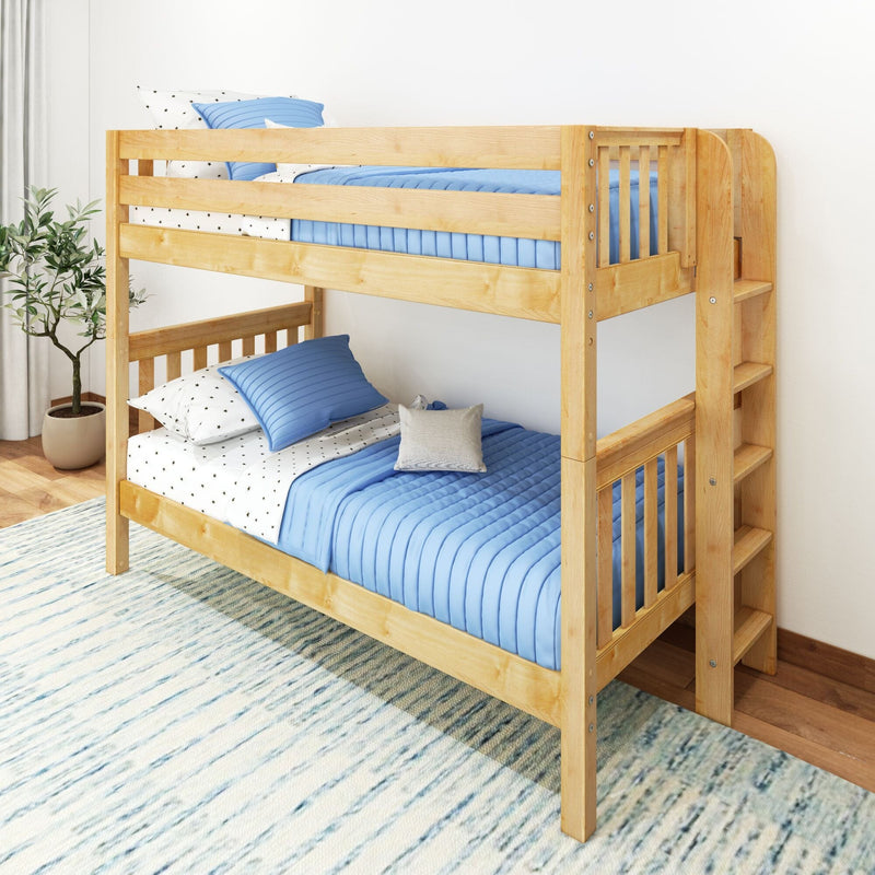 Solid pine twin-over-twin bunk bed with blue quilted bedding and built-in ladder shelves in a bright kids' bedroom