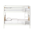 White wooden bunk bed with side ladder and natural wood slat accents, white bedding, modern children's bedroom furniture