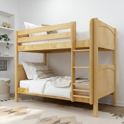 Solid natural pine twin-over-twin bunk bed with ladder in modern children's bedroom, space-saving wooden frame with white bedding and decorative pillows