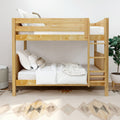 Natural pine wooden bunk bed with white bedding and ladder in a modern kids bedroom featuring a boho rug and potted plant