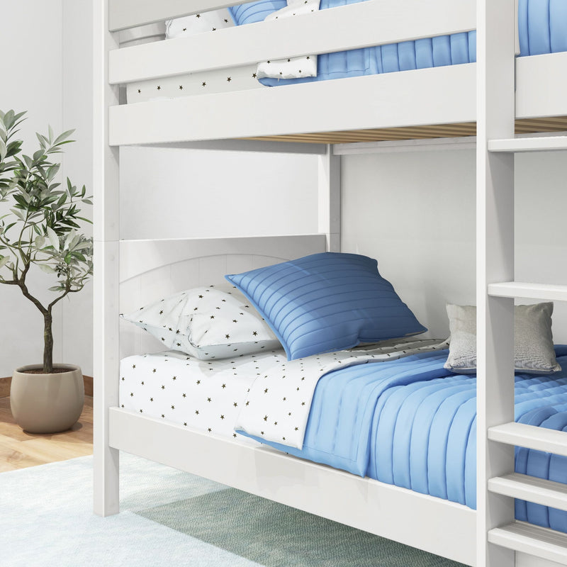 White wooden bunk bed with blue quilted bedding and star-print sheets in a modern kids' bedroom with potted plant