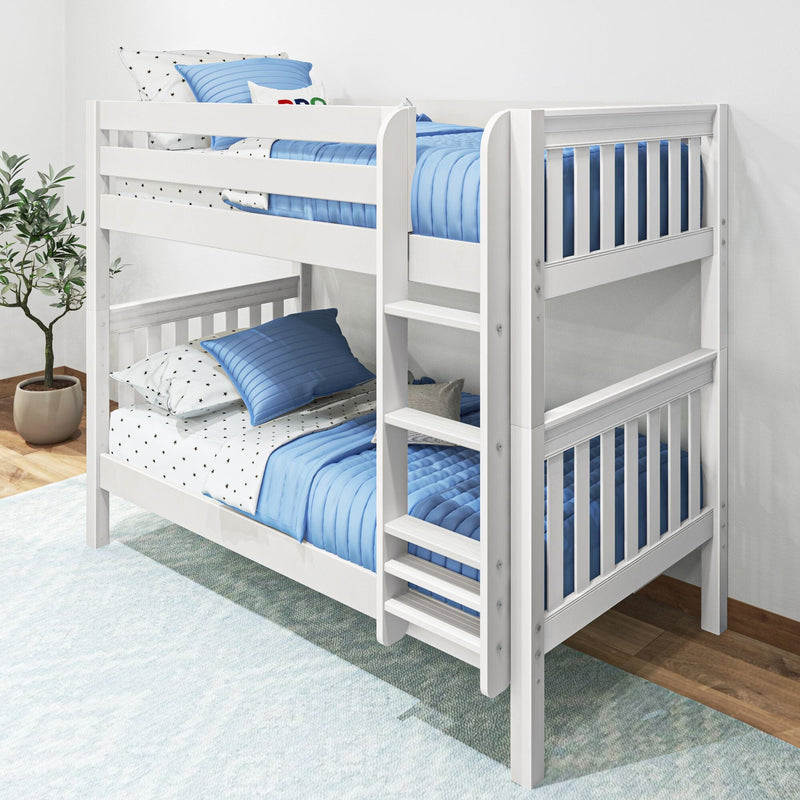 White wooden twin-over-twin bunk bed with blue quilts and pillows, ladder and safety rails in a modern kids' bedroom with potted plant and hardwood floor