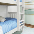 White wooden bunk bed with ladder and blue quilted bedding in a modern kids' bedroom with coastal wall art