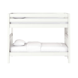 White wooden bunk bed with top guardrail and lower twin mattress dressed in white linens on a clean white background