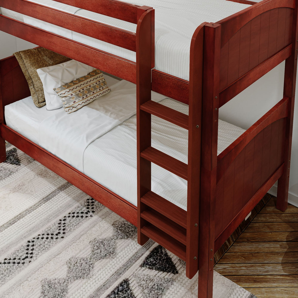 Wooden bunk bed with white bedding and decorative pillows on a cozy patterned rug in a modern bedroom.