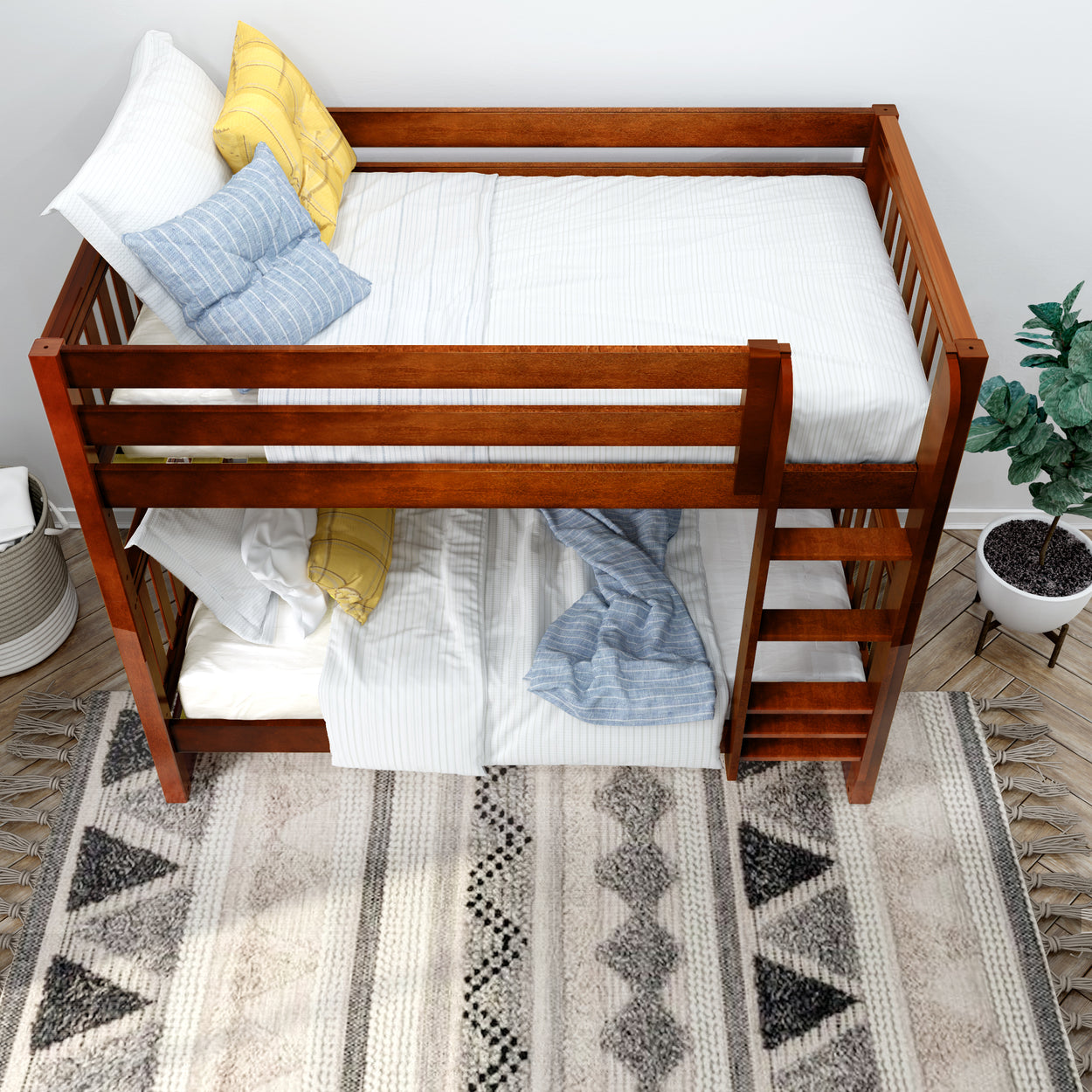 Wooden bunk bed with comfortable striped bedding and colorful pillows in a cozy modern bedroom.