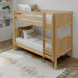 Wooden bunk bed with white bedding in a cozy, modern bedroom featuring a decorative rug and cozy pillows.