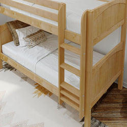 Wooden bunk bed with linens and pillows in a cozy bedroom setting.