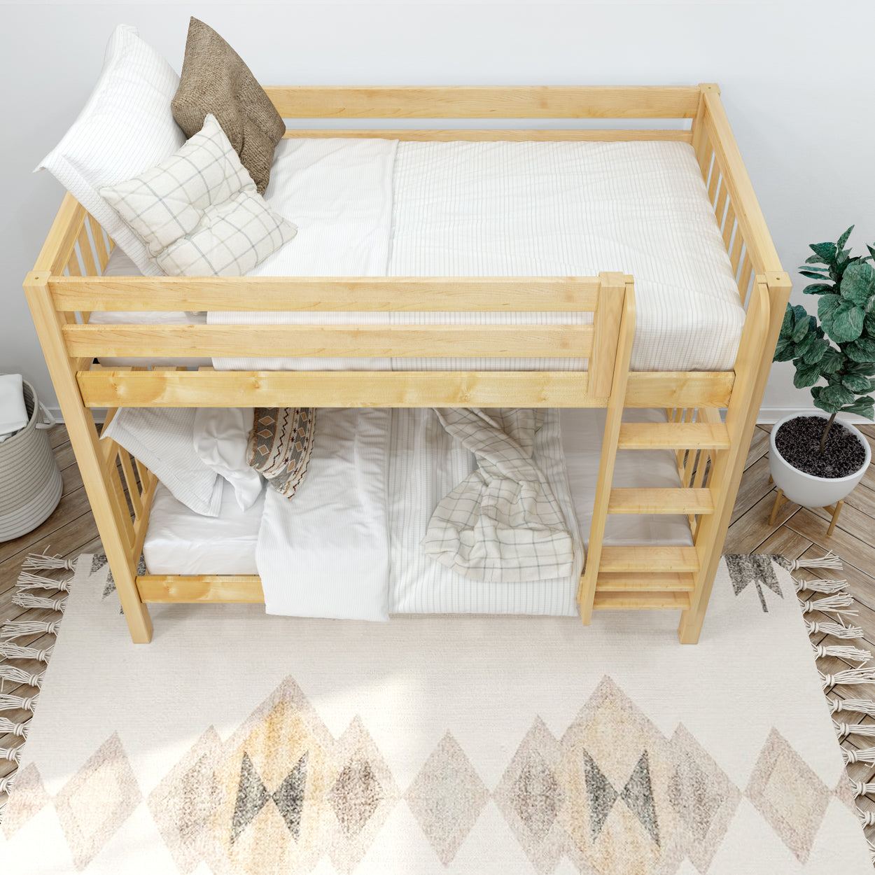 Top view of a wooden bunk bed with cozy bedding in a bright bedroom, featuring a plant and geometric rug, ideal for small spaces and children's rooms.