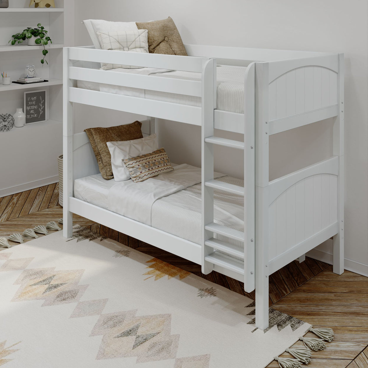 White wooden bunk bed in a modern bedroom with decorative pillows and patterned rug.
