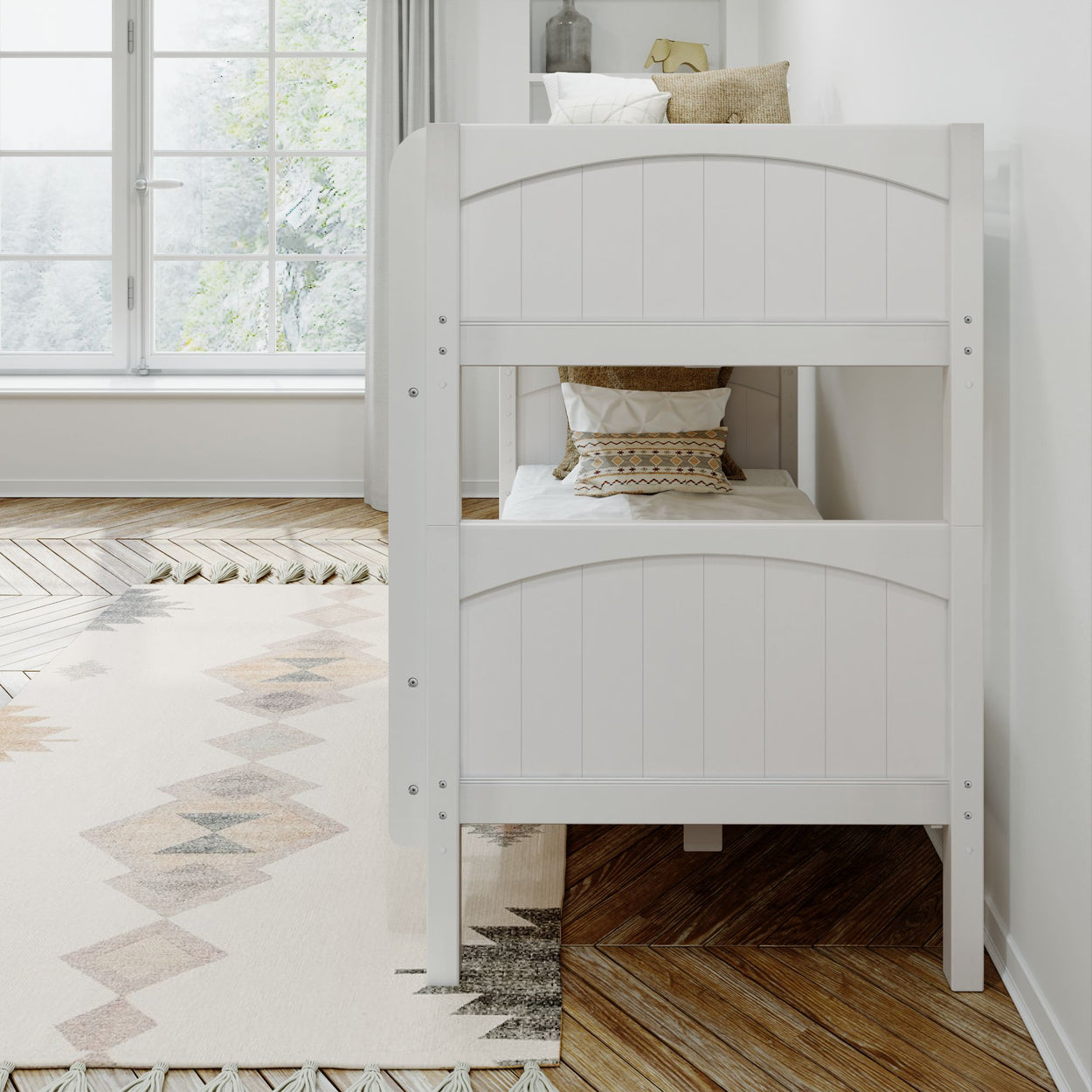 White wooden bunk bed with decorative pillows in a cozy, sunlit bedroom.