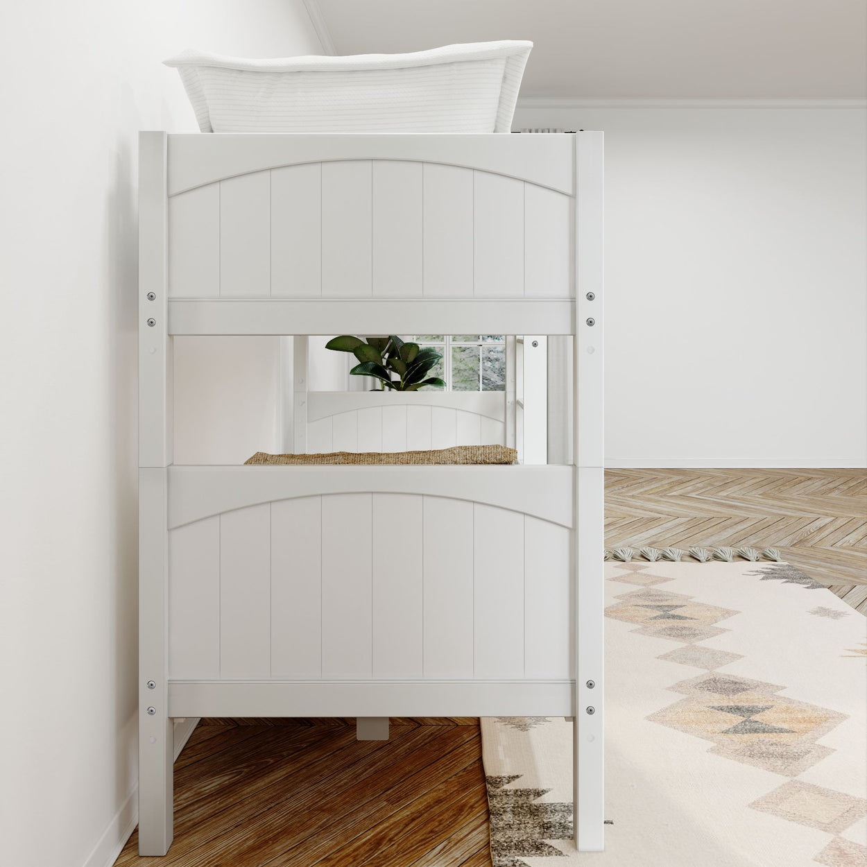 White wooden bunk bed in a minimalist bedroom with plant and geometric rug.