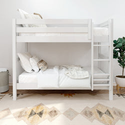 White wooden bunk bed in modern, minimalist bedroom with cozy bedding and decorative pillows.