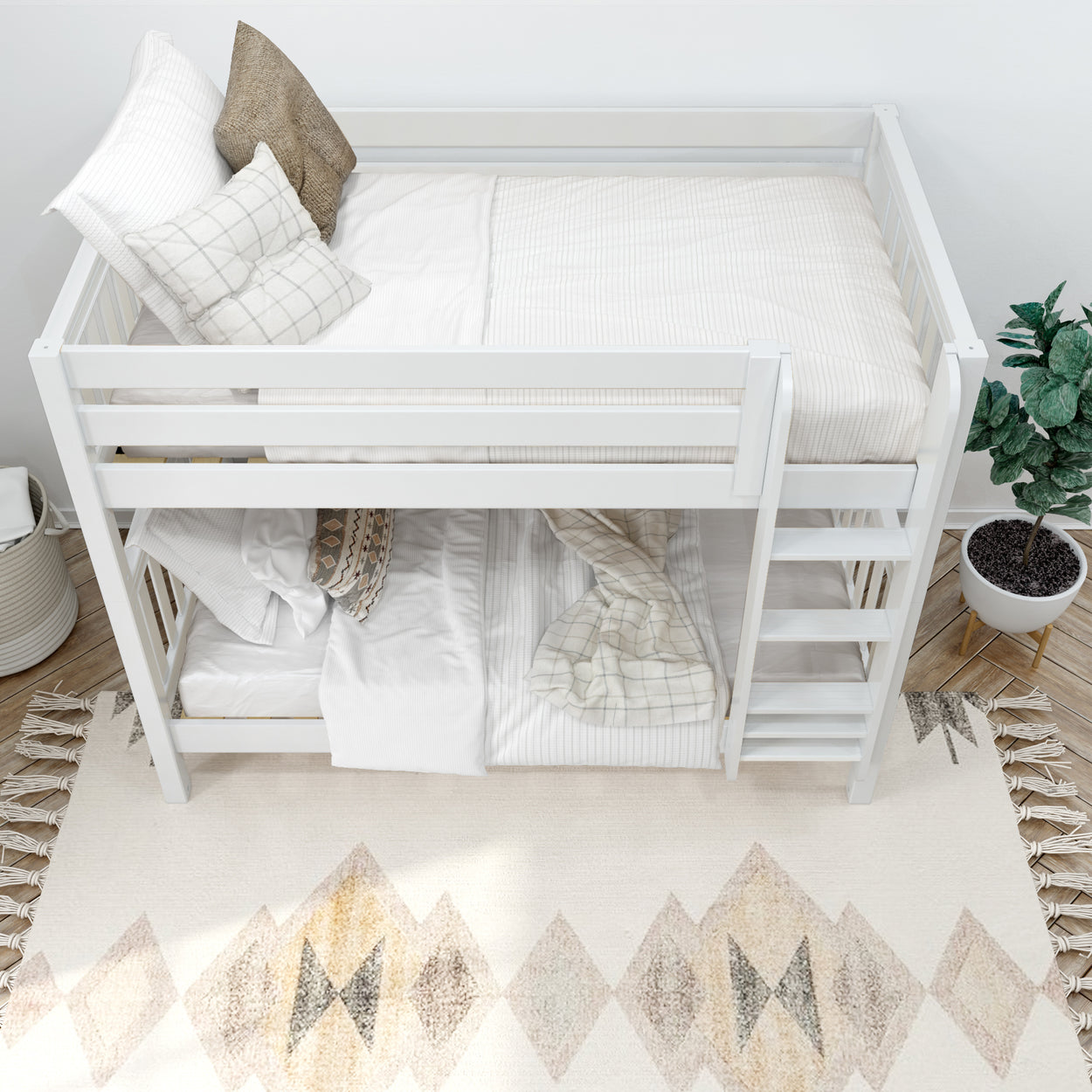 White wooden bunk bed with striped bedding and decorative pillows in a cozy bedroom interior.