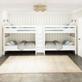 White twin bunk beds with storage ladder in modern kids' bedroom, gray bedding and blue pillows, beige shiplap wall, woven ceiling light and cream area rug