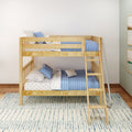 Natural wood twin-over-twin bunk bed in a children's room with blue quilted bedding, star-print sheets, safety rails, ladder and metal slide on hardwood floors and a patterned rug