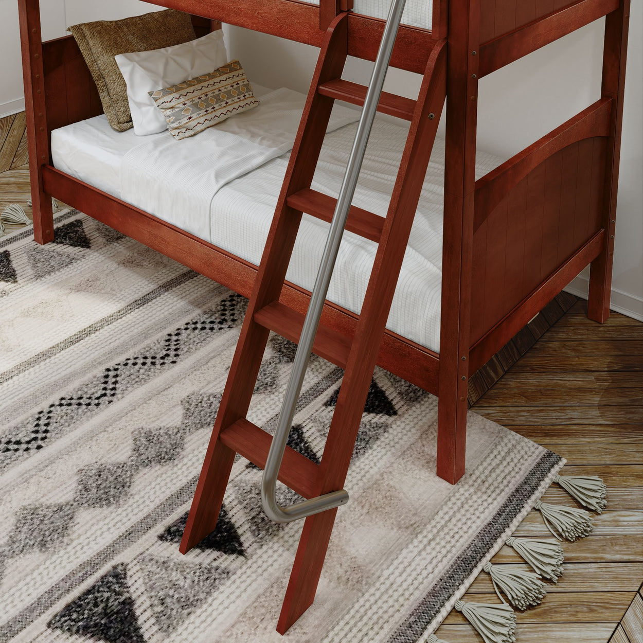 Red wooden bunk bed with ladder and decorative pillows on a geometric patterned rug in a modern bedroom.