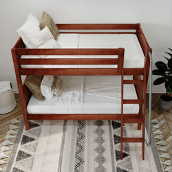 Wooden bunk bed with white bedding and cozy pillows in a modern bedroom setting featuring a patterned rug, ideal for maximizing space in small rooms.