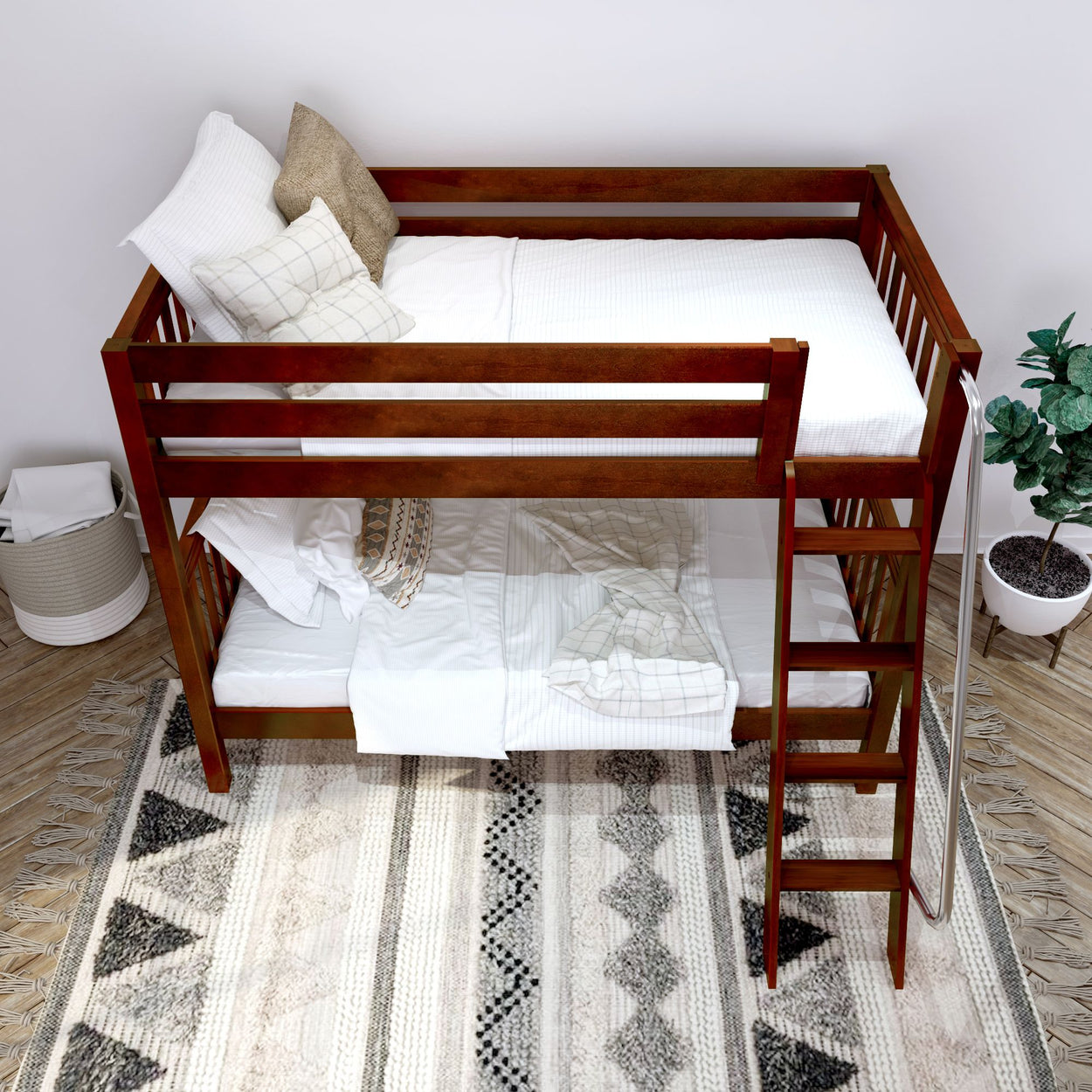 Wooden bunk bed with white bedding and decorative pillows in a cozy bedroom setting with a patterned rug.
