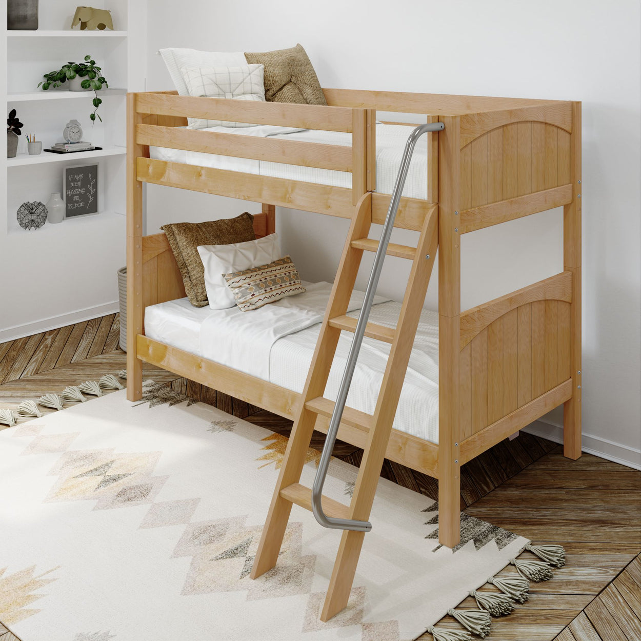 Wooden bunk bed with ladder in a cozy, modern bedroom featuring a geometric rug and decorative pillows.